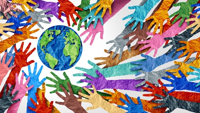 earth surrounded by lots of arms in different colors reaching toward it.